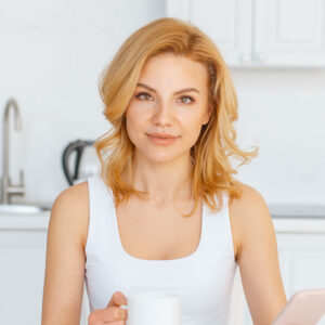happy-woman-at-the-table-with-fruits-and-baking-QSWAN3Y.jpg
